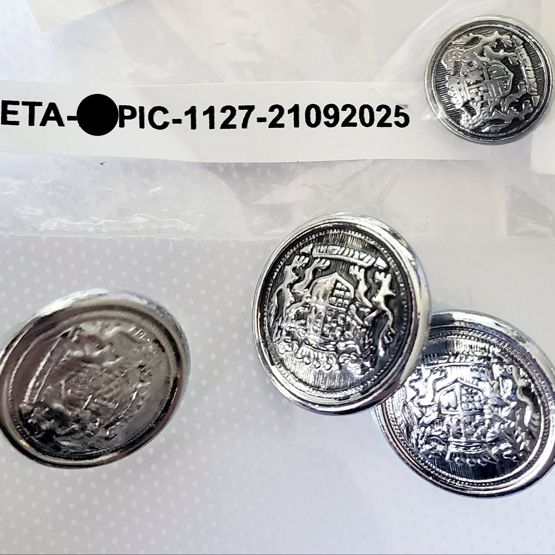 Silver colored shank style sewing buttons made from metal and emblem print